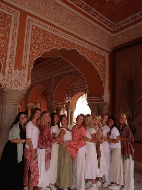 Group portrait of people in an intricately decorated building.