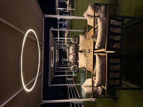 Outdoor seating area on a cruise ship at night.