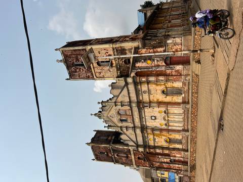 Old colonial building with weathered walls and architectural details.