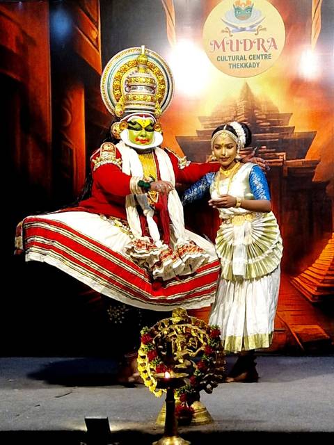       Traditional dancers performing a cultural dance in colorful attire.
  