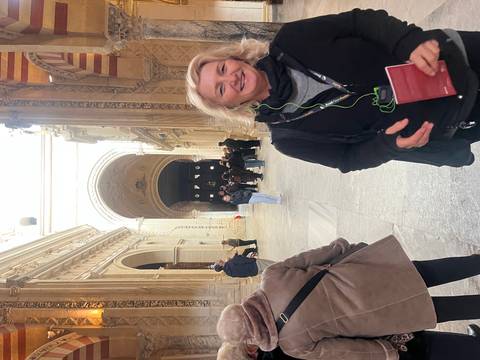 Tourists exploring the interior of the Mezquita with many arches.