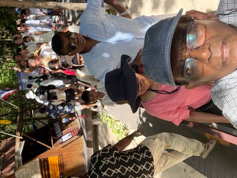 A crowded queue of tourists waiting at a tourist attraction in Thailand.