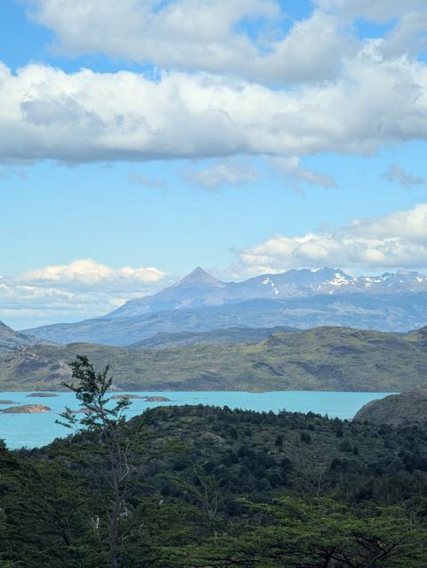 Distant mountains with snow seen across a lake.