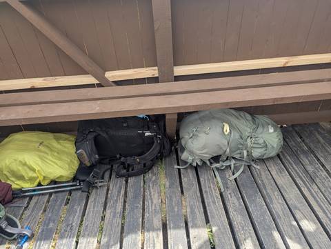 Backpacks placed on a wooden platform.