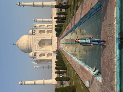 A person standing in front of the Taj Mahal.
