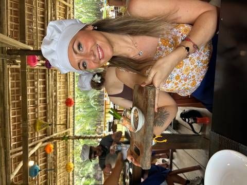 Woman showcasing a traditional dish in a cooking class.