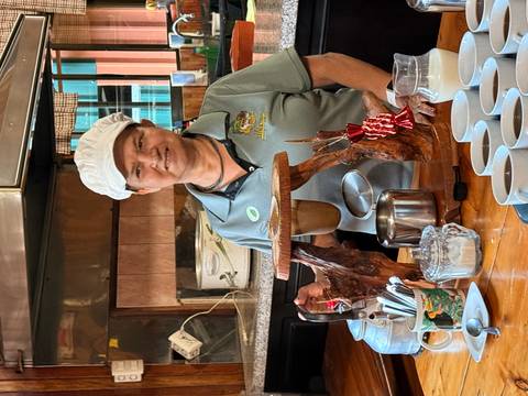 Woman preparing coffee with a traditional filter.