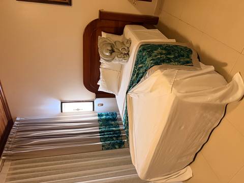       Hotel room with bed and towel folded into an animal shape.
  
