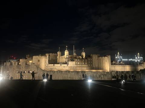 The Tower of London illuminated at night.