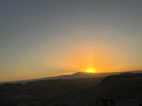 Sunset over a mountainous landscape.