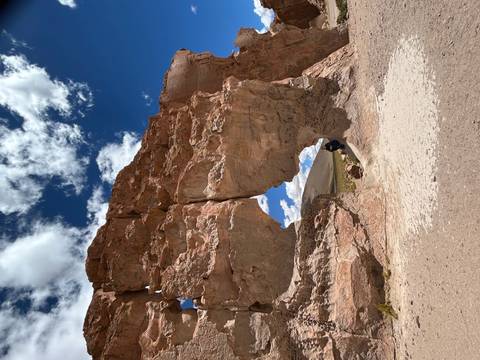 Natural rock formation with a clear blue sky.