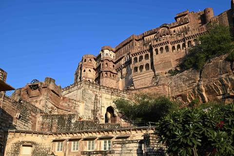 Large fortress with detailed architecture against a blue sky.
