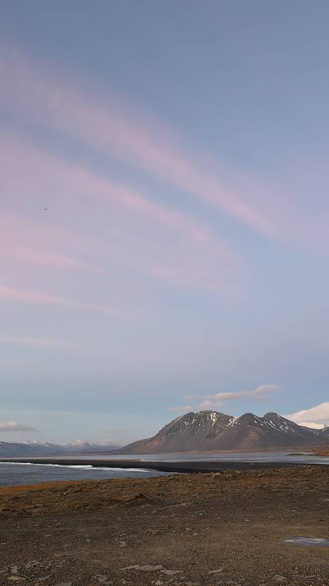       Pink sky with subtle cloud patterns.
  