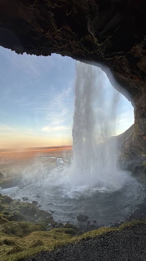 Waterfall cascading down in the sunlight.