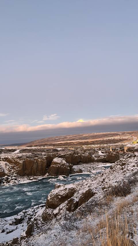 Landscape with bridge and snowy terrain.