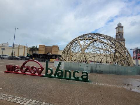 Architectural structure with Casablanca sign and people around.