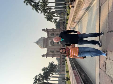       Couple standing in front of a grand building with a dome.
  