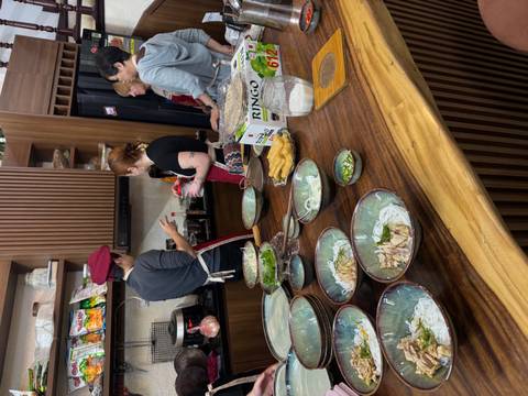 Group cooking class with ingredients laid out and participants engaged.