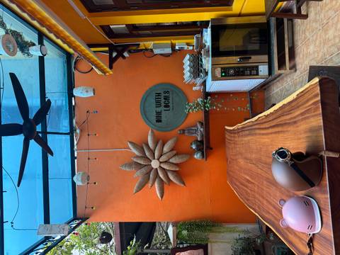       Interior view of a colorful dining area with 'Dine with Locals' signage.
  