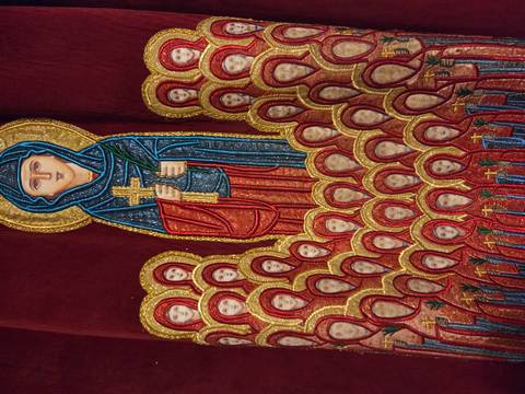 Close-up of a religious tapestry or artwork with colorful figures.