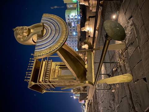       An elaborate Pharaonic sculpture at a museum display.
  