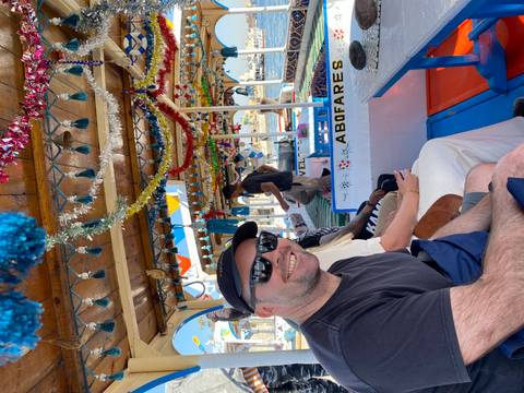       A group of people enjoying a decorated boat ride.
  
