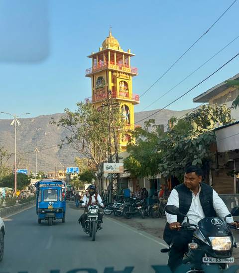 Busy street with two people on a motorbike