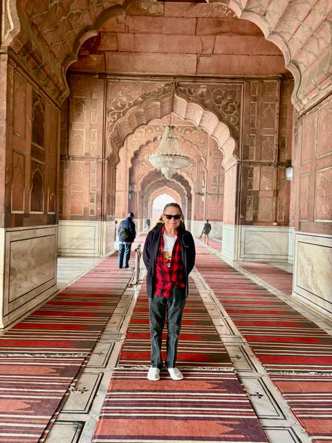 People inside a historic mosque hallway