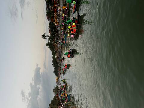       River scene with numerous boats and lantern decorations, likely Hoi An.
  