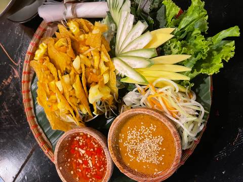 Traditional Vietnamese dish with various ingredients arranged on a plate.