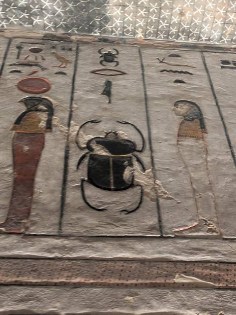       Close-up of an ancient wall with Egyptian carvings.
  