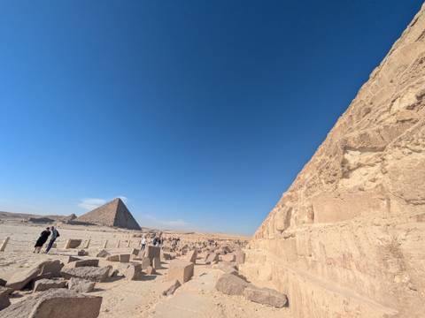 Walking tour near the pyramids with a vast desert landscape.