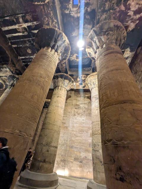 High columns with hieroglyphs inside an ancient structure.