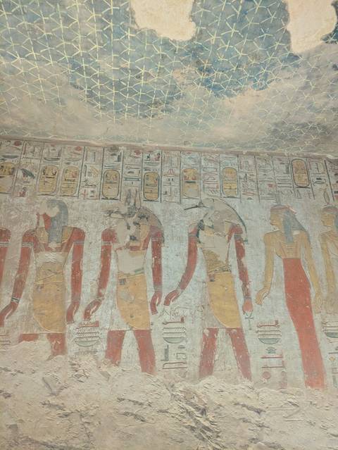       Ancient Egyptian wall painting with figures and hieroglyphs.
  