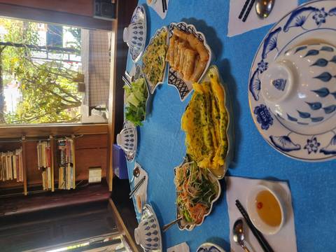 Vietnamese food served on a table with dishes and chopsticks.