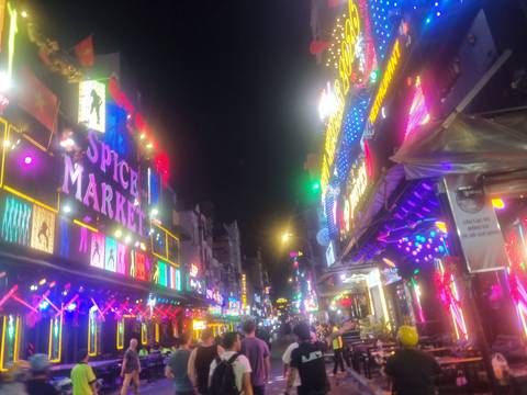 Person in a red jacket smiling in a snowy landscape.