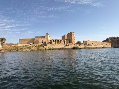 Philae Temple by the riverside under a sunny sky.
