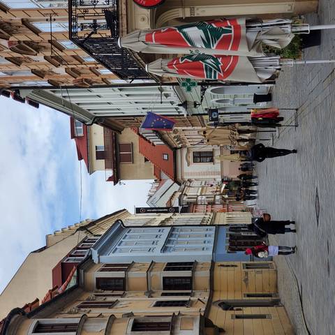      City street scene with pedestrians and colorful buildings.
  