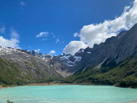 Scenic view of a blue glacier lake surrounded by rugged mountains.