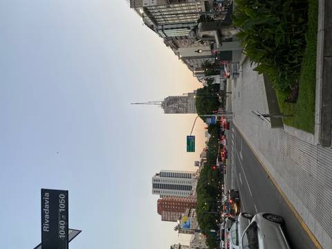 Urban street view with traffic and a prominent building in Buenos Aires.