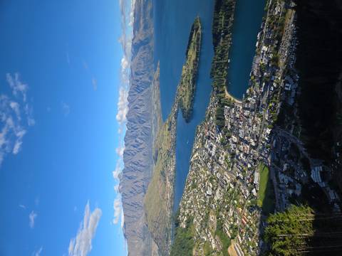 Overlooking a town with mountains in the background during daylight.