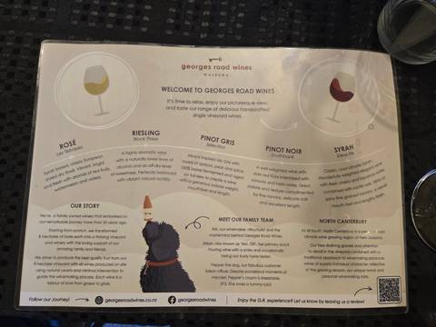 A menu or informational sign with text, featuring a drawing of a dog.