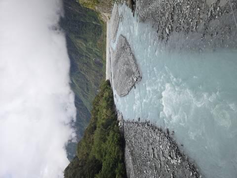 Bright river with turquoise water, surrounded by lush vegetation.