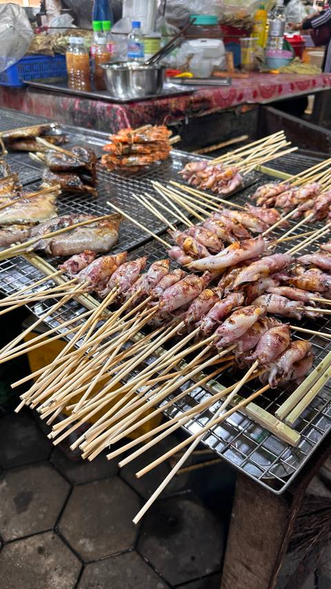 Grilled squid skewers on a grill.