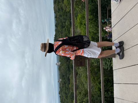       Woman at a high vantage point overlooking the Tikal ruins.
  