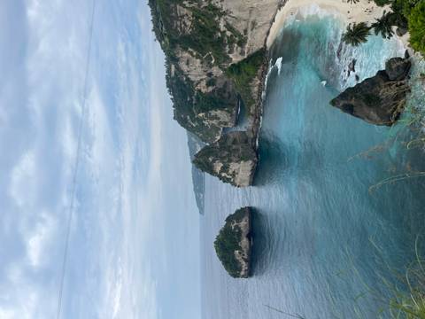 Cliffside view of turquoise waters and rock formations.