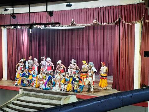 Cultural performance with dancers on stage in traditional outfits