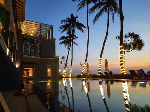       Swimming pool with modern architecture at sunset
  