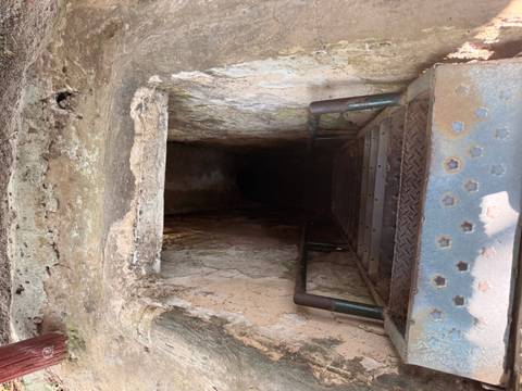 Entry to a tunnel with steps leading downwards.