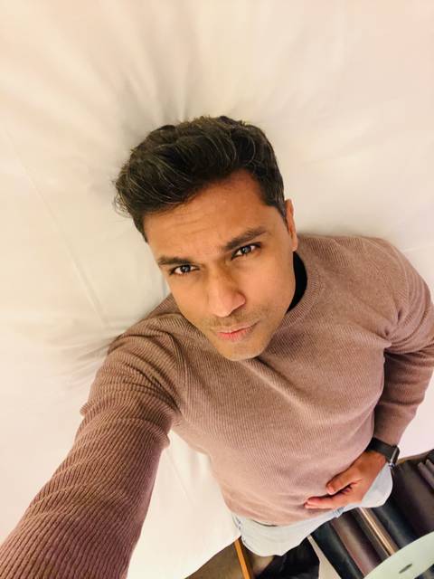 Close-up portrait of a man lying on a bed.